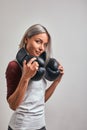 Young beautiful sexy woman boxer posing with black boxing gloves in her hands on a gray background. Copy space, gray Royalty Free Stock Photo