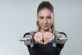 Young beautiful woman with brunette hair in a black t-shirt with metal dumbbells, portrait fitness sport photo Royalty Free Stock Photo