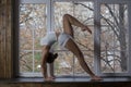 Young beautiful woman doing yoga on window Royalty Free Stock Photo