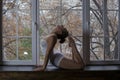 Young beautiful woman doing yoga on window Royalty Free Stock Photo