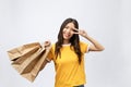 Young beautiful shopper woman with shopping bags shows two fingers. Isolated white background Royalty Free Stock Photo