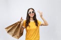 Young beautiful shopper woman with shopping bags shows two fingers. Isolated white background Royalty Free Stock Photo