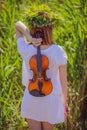 Girl with a violin behind her back Royalty Free Stock Photo