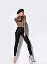 Young beautiful slim blond woman in leopard longsleeve, trousers, shoes and black beret