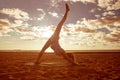 Young beautiful slim woman silhouette practices yoga on the beach at sunset. Yoga at sunrise Royalty Free Stock Photo