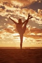 Young beautiful slim woman silhouette practices yoga on the beach at sunset. Yoga at sunrise Royalty Free Stock Photo