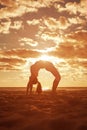 Young beautiful slim woman silhouette practices yoga on the beach at sunset. Yoga at sunrise Royalty Free Stock Photo