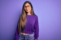 Young beautiful smart woman wearing glasses over purple isolated background Relaxed with serious expression on face Royalty Free Stock Photo