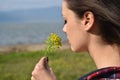 Young beautiful smells flowers Royalty Free Stock Photo