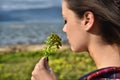 Young beautiful smells flowers Royalty Free Stock Photo