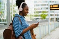 Young beautiful smiling african woman in headphones with phone Royalty Free Stock Photo