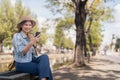 Young beautiful smiling asian woman tourist in city street using mobile phone check direction or use social media Royalty Free Stock Photo