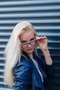 Young beautiful smiling blonde girl with beautiful appearance and long hair. Portrait of a woman with long hair and amazing looks. Royalty Free Stock Photo