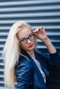 Young beautiful smiling blonde girl with beautiful appearance and long hair. Portrait of a woman with long hair and amazing looks. Royalty Free Stock Photo