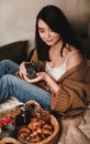 Young beautiful smiling brunette woman enjoying breakfast in bed Royalty Free Stock Photo