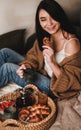 Young beautiful smiling brunette woman enjoying tasty breakfast in bed Royalty Free Stock Photo