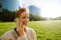 Young beautiful smiling business woman talking phone and looking aside Royalty Free Stock Photo
