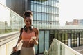Young beautiful smiling fit afro woman with phone and mat Royalty Free Stock Photo