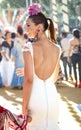 Young beautiful smiling woman dressed in traditional costumes at the Seville`s April Fair