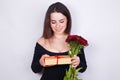 Young beautiful smiling woman with flowers and gift. Dating, rel Royalty Free Stock Photo