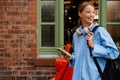 Young beautiful smiling woman in shirt with phone and bicycle Royalty Free Stock Photo