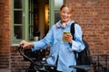 Young beautiful smiling woman in shirt with phone and bicycle Royalty Free Stock Photo