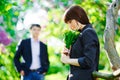 Young beautiful smiling woman smells small bouquet Royalty Free Stock Photo