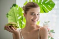 Young beautiful smilling girl holds a burger in hand