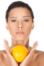 Young beautiful spa woman with orange in her hand