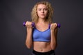 Young beautiful sport woman ready for gym holding dumbbells Royalty Free Stock Photo