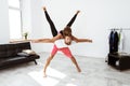 Young beautiful sportive couple practicing partner yoga asanas at home.