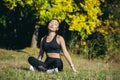 Young beautiful sports girl asian woman meditating in park, sitting lotus pose practicing yoga mat, zen. relaxes outdoors in Royalty Free Stock Photo