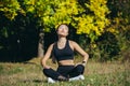 Young beautiful sports girl asian woman meditating in park, sitting lotus pose practicing yoga mat, zen. relaxes outdoors in Royalty Free Stock Photo