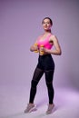 Young beautiful sports girl in leggings and a top does exercises with dumbbells. Healthy lifestyle. A woman goes in for sports at Royalty Free Stock Photo