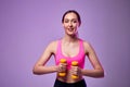 Young beautiful sports girl in leggings and a top does exercises with dumbbells. Healthy lifestyle. A woman goes in for sports at Royalty Free Stock Photo