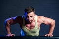 Young and beautiful sportsman athlete bodybuilder man doing exercises for muscles of the body in the gym