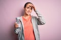 Young beautiful sporty woman doing sport drinking bottle with water to refreshment stressed with hand on head, shocked with shame Royalty Free Stock Photo