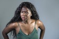 Young beautiful and stressed black African American woman feeling upset and angry gesturing agitated and looking crazy and Royalty Free Stock Photo