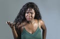 Young beautiful and stressed black African American woman feeling upset and angry gesturing agitated and looking crazy and Royalty Free Stock Photo