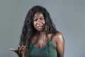 Young beautiful and stressed black African American woman feeling upset and angry gesturing agitated and looking crazy and Royalty Free Stock Photo