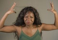 Young beautiful and stressed black African American woman feeling upset and angry gesturing agitated and looking crazy and Royalty Free Stock Photo