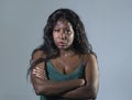 Young beautiful and stressed black African American woman feeling upset and angry looking serious and posing with folded ar Royalty Free Stock Photo