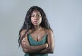 Young beautiful and stressed black African American woman feeling upset and angry looking serious and posing with folded ar Royalty Free Stock Photo