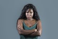 Young beautiful and stressed black African American woman feeling upset and angry looking serious and posing with folded ar Royalty Free Stock Photo