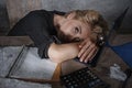 Young beautiful stressed and sad blonde woman working with laptop computer feeling tired sitting at office desk overwhelmed by pap Royalty Free Stock Photo