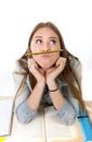 young beautiful student holding pen between nose and lips as mou Royalty Free Stock Photo