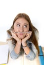 Young beautiful student holding pen between nose and lips as mustache Royalty Free Stock Photo