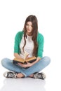 Young beautiful student sitting with book, reading, learning. Royalty Free Stock Photo