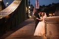 Young beautiful stylish pair of newlyweds on a bridge in Budapest