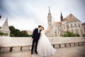 Young beautiful stylish pair of newlyweds kissing by the Fisherman`s Bastion in Budapest, Hungary